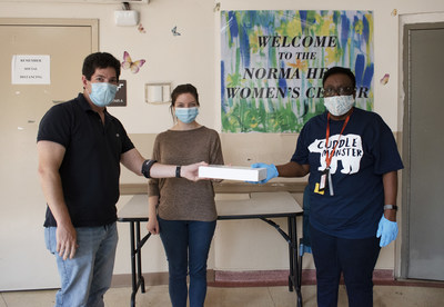 Cleanlife representatives Rick Solomon (left) and Liz LeDonne (center) present Ebony Naylor (right) of the Norma Herr Women's Shelter one of the new PPE kits.