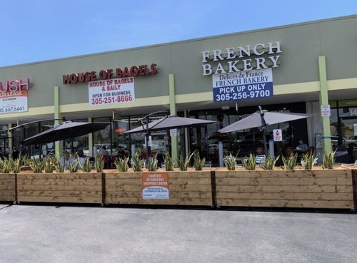 Landlord provides tenants outdoor seating in parking lot to help them stay in business.