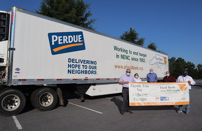 Perdue Farms and the Food Bank of the Albemarle unveil a new 53-foot refrigerated tractor-trailer that was funded by a $100,000 Perdue Foundation grant. From left to right are Will Meiggs, board member of the Food Bank of the Albemarle; Liz Reasoner, food bank executive director; Jeff Stalls, Perdue director of operations in Lewiston; Guy Burkholder, Perdue human resources manager; and Andy Spencer, director of food bank operations.
