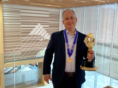 Sterling Nielsen, Mountain America Credit Union's president and CEO, displays the Best of State Statue (Business Services division) and Best of State Medal (Financial Services category).