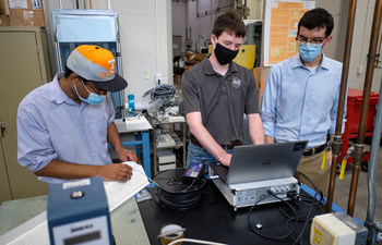 From left, Dr. Dayakar Penumadu’s research group member Dr. Stephen Young, and graduate students Andrew Patchen and Joey Michaud are part of the University of Tennessee’s team in Knoxville working to equip the fiber reinforced polymer bridge deck with high-density fiber optic and fiber Bragg grating sensors to monitor long-term durability.