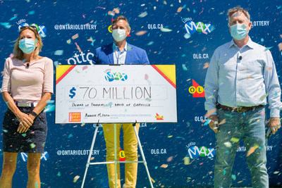 OLG Vice President of Brand and Marketing, Randy Weyersberg, celebrates a $70 million win with Donna Williamson of Thornhill and David Overall of Oakville at OLG Play Stage in Toronto. The friends won the jackpot from the Friday, July 31, 2020 LOTTO MAX draw. (CNW Group/OLG Winners)