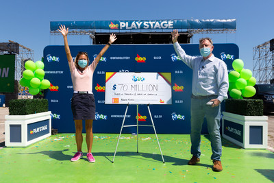 Donna Williamson of Thornhill and David Overall of Oakville accept their $70 million cheque at OLG Play Stage in Toronto. The friends won the jackpot from the Friday, July 31, 2020 LOTTO MAX draw. (CNW Group/OLG Winners)