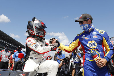 Marco Andretti is congratulated by fellow Honda driver Alexander Rossi after qualifying on the pole for the 104th Indianapolis 500