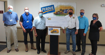 Perdue Farms representatives present a $10,000 grant to the Albemarle Area United Way to support Bertie County tornado relief efforts. From left to right are Jeff Stalls and Frank Koekkoek with Perdue, Ron Wesson and John Trent with the Bertie County Board of Commissioners, and Bill Blake and Julie Phelps with Albemarle Area United Way.