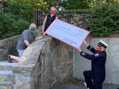 Lt. Ralph Blight, of (IAFF) Local 792 in Quincy, Massachusetts (right) delivers $9,000 to Cure Alzheimer's Fund President & CEO Tim Armour (left) and VP, Development Operations and Fundraising Laurel Lyle.(center) raised earlier this year at its 5th annual bowling fundraising event.