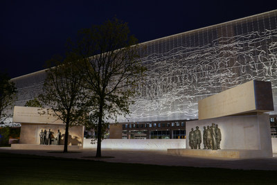 Framing the new Dwight D. Eisenhower Memorial, lit at night, is a stainless steel woven tapestry depicting the Normandy coastline in peacetime.
