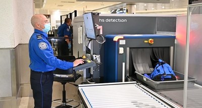 TSA officer inspecting items using new CT technology