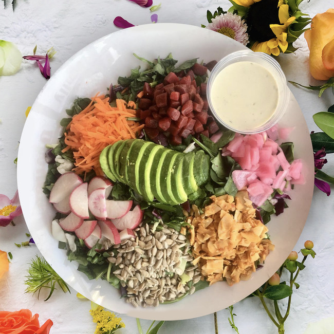 Emmas Detox Salad features pickled onions, beets, sunflower seeds, carrots, radish, avocado, and house-made garden ranch dressing.