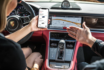Customer explores the Porsche Drive app. Since the pandemic, social distancing and other safety measures have been put in place during vehicle flips.
