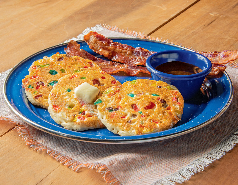 Kids Mini Confetti Pancakes include three mini pancakes filled with fruity cereal served with syrup n’ butter.