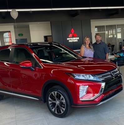 Dan Arrotta poses with his wife in the showroom of the all-new Arrotta’s Mitsubishi.