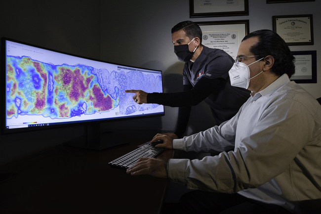 Pathologists at CorePlus review a cancer heatmap generated using AI