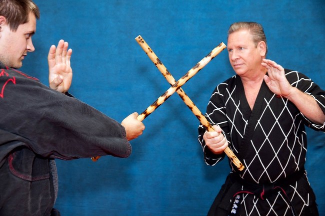 Master David Garrison and Dean Corbin demonstrate single stick Kali techniques from the yellow belt requirements of the GarrisonWeapons.com curriculum.
As the first weapon in the program students learn the angles of attack and the proper blocking that will carry over to all the next weapons in the system.