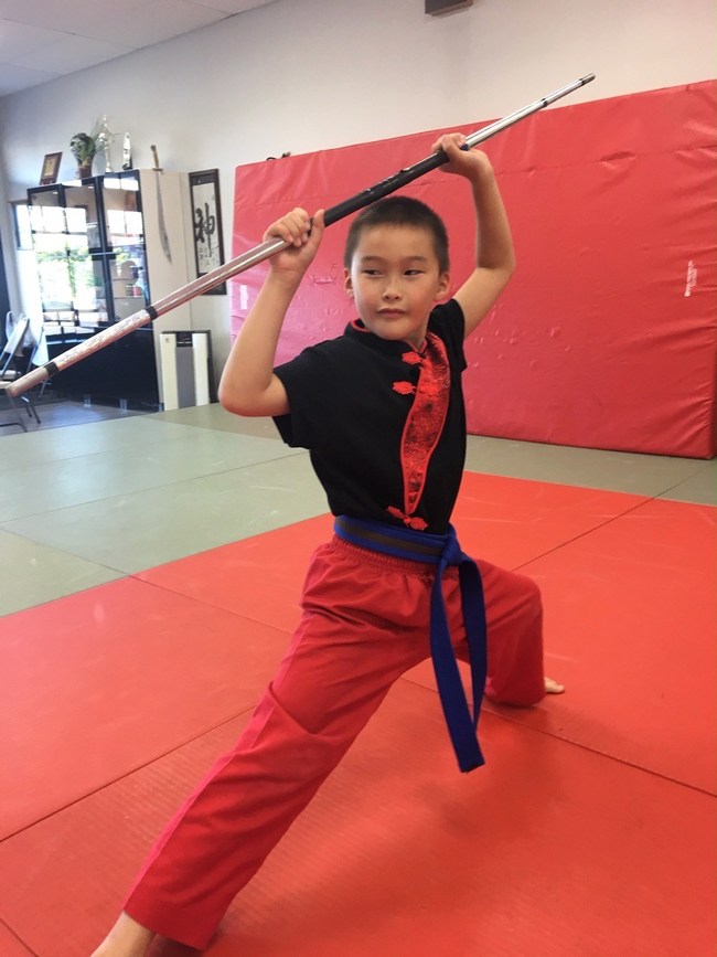 GarrisonWeapons.com student Jermey Brice executes the classical pose in the Tiger Tail Bo Staff kata that is required to earn Orange belt rank.
As a tournament competitor Jermey has consistently placed 1st in weapons using Bo Staff in competition with forms from the system.