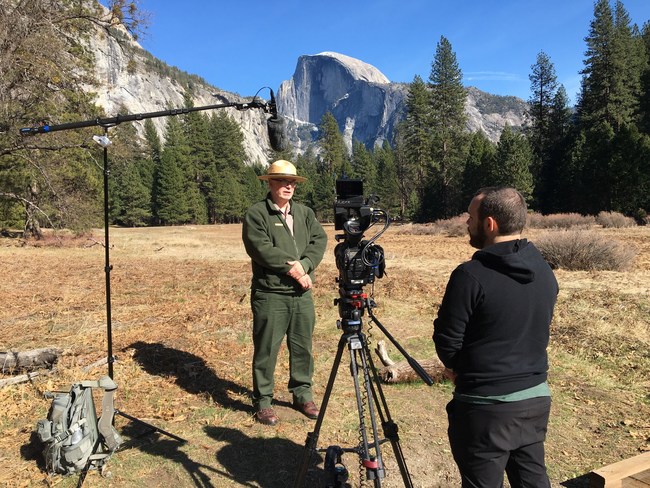 Brian Rolling filming a client at Yellowstone National Park