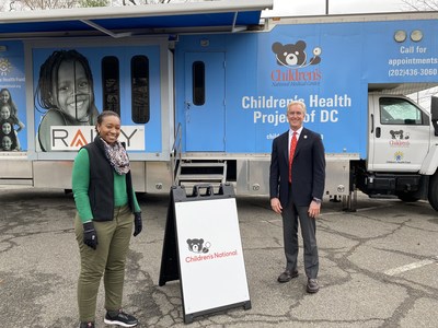 Kevin Reilly, Board Member of Hyundai Hope On Wheels and President of Alexandria Hyundai, speaks with staff member at the Children's National COVID-19 testing center in Washington, D.C