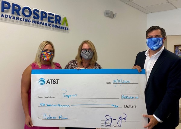 AT&T Florida Director of Corporate External and Legislative Affairs Alex Dominguez and AT&T Regional Director of External and Legislative Affairs Thais Asper present Believe Miami Donation to Prospera South Florida Vice President Myrna Sonora