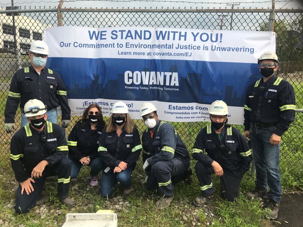 Covanta Essex employees stand outside the Newark, NJ facility with a banner in support of the community and environmental justice