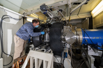 Matthew Wolford, a U.S. Naval Research Laboratory research chemist, inspects an argon fluoride (ArF) laser to be tested with new thicker stainless foils at Washington, D.C. June 1, 2020. Wolford was part of a team of researchers who outfitted the ArF laser with new foils in hopes of increasing laser output. The ArF laser is the world’s largest studying the physics of developing a high efficiency electron-beam pumped ArF laser at 193 nanometers. (U.S. Navy photo by Jonathan Steffen)