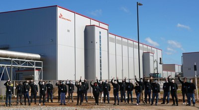 The initial group of employees for SK Battery America's facilities in Georgia stand in front of the first plant at site. SK Battery America has 60 employees with plans to hire more than 1,000 by the end of next year at the site in Commerce, Ga., to make batteries for electric vehicles.