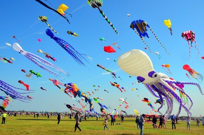 Players fly various creative kites at Weifang Binhai Economic and Technological Development Zone on September 26
