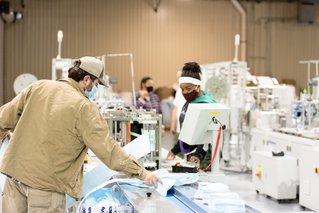 Vidalia Mills employees operate new machinery to manufacture masks in Vidalia, Louisiana.