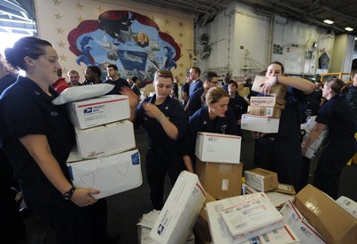 Sailors sort boxes during a mail call aboard USS Dwight D. Eisenhower in the Arabian Sea. (U.S. Navy photo by Petty Officer 3rd Class Ryan D. McLearnon)