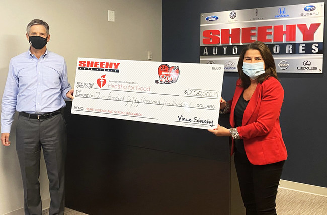 Vince Sheehy, President of Sheehy Auto Stores, presents a check to Soula Antoniou, Executive Director of the American Heart Association.
