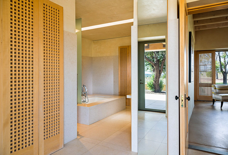 Shown here: the master bath of Landau-Fisher’s “Windland House.” While completed in the early 2000’s, its forward-thinking, modern design – in addition to its exceptional quality of craftsmanship – makes the residence appear as if it was built within the past few years. The home’s design garnered several, impressive architecture awards. Discover more at NewMexicoLuxuryAuction.com.