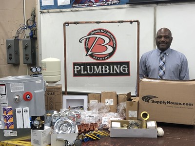 Anthony Johnson, BX Design Plumbing Instructor, with donated supplies from SupplyHouse.com