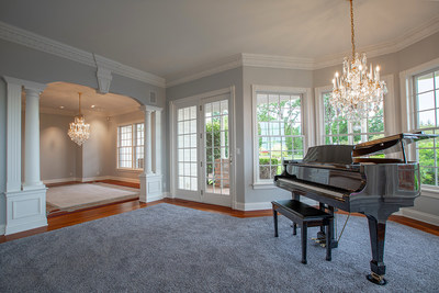 Interiors are done in a “relaxed luxury” style, as shown here in the entry level’s music room. The main residence offers approx. 7,500 square feet, with 5 beds and 6.5 baths. Learn more at OregonLuxuryAuction.com.