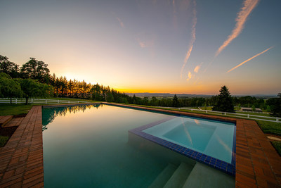 Relaxing and seductive sunset views – as the sun sinks behind the surrounding hills and valleys – can be enjoyed from the estate’s custom pool and spa. Learn more at OregonLuxuryAuction.com.