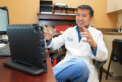 Kenneth Ngo, MD, Medical Director and board-certified physical medicine and rehabilitation physician at Brooks Rehabilitation in Jacksonville, Fla., conducts telehealth visits with patients during the COVID-19 pandemic. (PRNewsfoto/Brooks Rehabilitation)