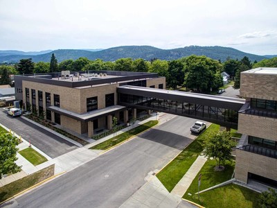 The Flathead County South Campus sky bridge designed by Cushing Terrell facilitates not only indoor pedestrian access between two buildings but also blends two eras of building architecture with visual continuity of independent materials. The enclosed pedestrian bridge comprised of two HSS steel Pratt trusses supported independently on concrete piers spans 95 ft.