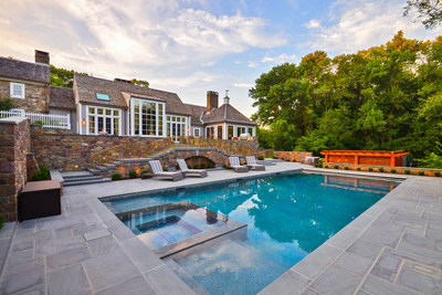 Hand-laid bluestone was used extensively in the outdoor living areas, which include a summer kitchen, lounge area with firepit, a heated, 34,000-gallon saltwater pool with infinity-edge spa and electronic solar cover, and lighted walkways and landscaping. NewJerseyLuxuryAuction.com.