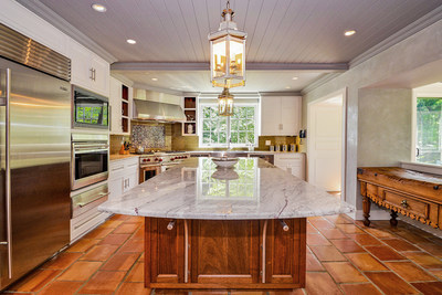 Seen here, the residence’s kitchen. The large, center island is mahogany with a marble top. Overhead lanterns were hand crafted in London in sterling silver. A lovely sunroom (not shown) is adjacent to the kitchen. NewJerseyLuxuryAuction.com.