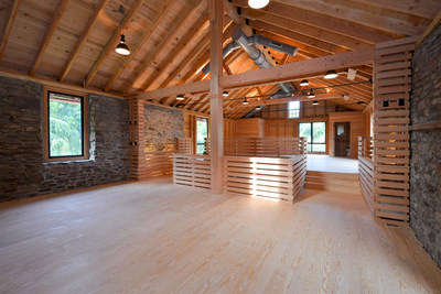 Inside the central barn’s upper level. Post-and-beam construction includes the use of fir, cedar, cypress and yellow pine woods. Black steel rods and ties, slatted walls and wrought iron railings create a modern, “polished industrial” feel. The building has been used by the owners for hosting events at the property, including a few private weddings for friends. NewJerseyLuxuryAuction.com.