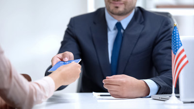 Illustration of a border officer handing a traveler a passport.