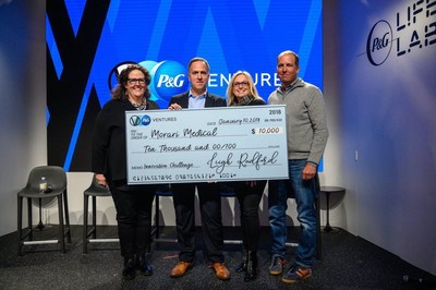 P&G Ventures Senior Vice President Leigh Radford presents $10,000 check to Morari Medical founder and CEO Jeff Bennett for winning the first P&G Ventures Innovation Challenge.