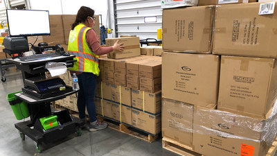 Protective gear, including isolation gowns and gloves, is staged for shipment in Direct Relief's warehouse on Nov. 5, 2020. Health facilities across the U.S. have continued requesting PPE and other medical essentials as Covid-19 cases spike. (Maeve O'Connor/Direct Relief)