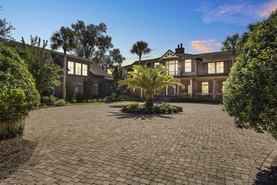 The nearly 8,000-sf estate emits a welcoming glow in the evening. There is also a separate guesthouse (partially shown here, at left) above a 3-car garage, with quarters that include a full bed and bath, kitchenette and plenty of living area. The property was custom built in 2007 by the current owner, who is now selling the home after using it much less over the years. Learn more at GeorgiaLuxuryAuction.com.