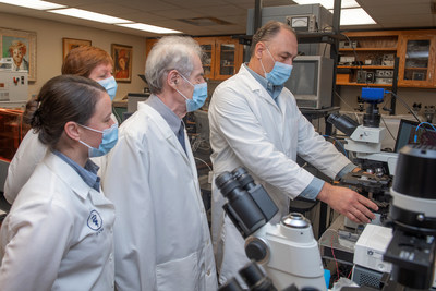 Auburn University researcher Oleg Pustovyy, right, prepares a slide for optical microscopy. An Auburn research team has made the first discovery of metal nanoparticles occurring naturally in an animal body, specifically zinc nanoparticles in nose cells, which has implications in possibly restoring or enhancing an animal’s or person’s sense of smell. Pictured, from left, are Melissa Singletary, Ludmila Globa, Vitaly Vodyanoy and Pustovyy. Not pictured are June Lau and Samantha Hagerty.