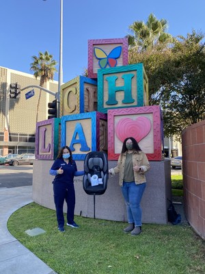 Go Insurance employee (right) and CHLA employee (left) participating in a socially distant Children's Hospital Los Angeles car seat distribution.