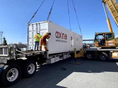 An Axine wastewater treatment system is loaded onto a truck for transport to the pharmaceutical plant. (CNW Group/Axine Water Technologies)