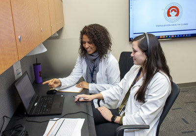 Courtney Gamston, left, a professor of experiential practice in Auburn University's Harrison School of Pharmacy and a 2013 pharmacy alumna, works with student Callie Seales, a member of pharmacy's Class of 2022, in the new Population Health Clinic. The collaboration between Auburn and the Tuscaloosa Veterans Affairs Medical Center allows for Auburn faculty and students to use telemedicine to help improve health outcomes of veterans in Alabama.