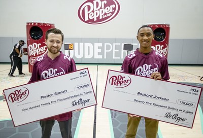 Preston Barnett, left, and Roshard Jackson pose with their novelty checks after competing in the 2020 Dr Pepper Tuition Giveaway football throw competition on Monday, Nov. 16, 2020 in Frisco, Texas. (Brandon Wade/AP Images for Keurig Dr Pepper)
