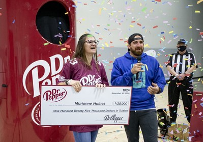 Marianne Haines, left, is interviewed by Dude Perfect member Tyler "Ty" Toney after competing in the 2020 Dr Pepper Tuition Giveaway football throw competition on Monday, Nov. 16, 2020 in Frisco, Texas. (Brandon Wade/AP Images for Keurig Dr Pepper)