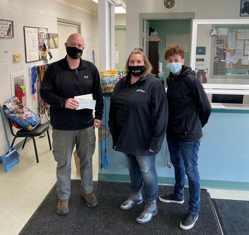 Petland Athens, OH General Manager Sally Jo Kuntz and Petland District Manager Nicole Soule present a $1,000 check to Ryan Gillette with the Athens County Dog Shelter. Gillette said the funds will be put into their sick and injured fund to offset the cost of medical treatments.