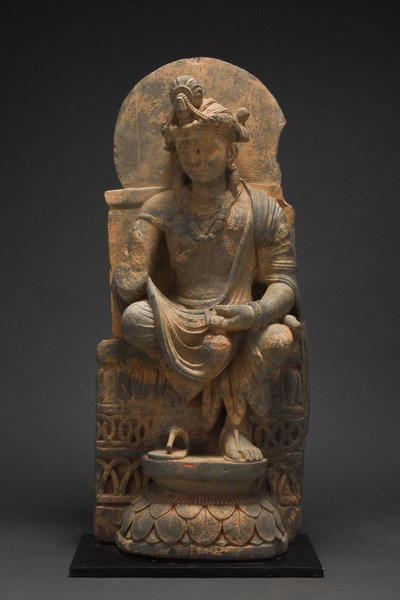 Giant Gandhara schist stone figure of seated, serenely composed Bodhisattva backed by a halo, 100-300 AD. Height: 740mm (29.1in). Estimate £9,000-£15,000